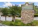 Stone sign for Hampton Arbors, with a manicured landscape enhancing the community's welcoming ambiance at 717 Beaufort Cir, Duluth, GA 30096