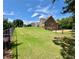 Large, green backyard with a well-maintained lawn at 8967 Midlothian Ct, Winston, GA 30187