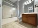 Bathroom featuring a shower over bath and wooden vanity at 8967 Midlothian Ct, Winston, GA 30187
