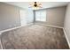 Spacious carpeted bedroom with ceiling fan, neutral walls, and window at 8967 Midlothian Ct, Winston, GA 30187