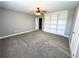 A well-lit bedroom with built-in shelving and plush carpeting at 8967 Midlothian Ct, Winston, GA 30187