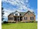 Charming brick two-story home featuring a well-manicured lawn and a welcoming front porch at 8967 Midlothian Ct, Winston, GA 30187