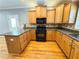 Kitchen boasting stainless steel appliances, wooden cabinets, and stone countertops at 8967 Midlothian Ct, Winston, GA 30187