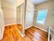 Large walk-in closet with hardwood floors, shelving, and mirror at 8967 Midlothian Ct, Winston, GA 30187