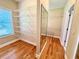 Well-organized walk-in closet with shelving, hardwood floors, and natural light at 8967 Midlothian Ct, Winston, GA 30187