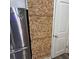 Intriguing accent wall crafted from wine corks next to a stainless steel refrigerator at 201 Jonquil Spring Rd, Woodstock, GA 30188