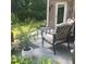 Cozy back patio featuring comfortable seating, potted plants, and a tranquil outdoor space for relaxation at 201 Jonquil Spring Rd, Woodstock, GA 30188