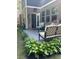 View of brick back patio with seating, grill, and lush green plants, creating a cozy outdoor space at 201 Jonquil Spring Rd, Woodstock, GA 30188
