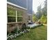 Back yard featuring patio with outdoor seating, a grill, and manicured landscaping with green lawn at 201 Jonquil Spring Rd, Woodstock, GA 30188
