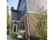 Brick and blue home with a patio, greenery, and small outdoor seating area at 201 Jonquil Spring Rd, Woodstock, GA 30188