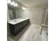 Modern bathroom with dual sinks, tile floors, and walk-in shower at 201 Jonquil Spring Rd, Woodstock, GA 30188