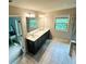 Well-lit bathroom with double vanity, modern fixtures, and stylish tile flooring at 201 Jonquil Spring Rd, Woodstock, GA 30188