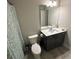 Well-lit bathroom with vanity, sink, and shower at 201 Jonquil Spring Rd, Woodstock, GA 30188