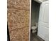 Unique accent wall made of wine corks and a toilet in the bathroom at 201 Jonquil Spring Rd, Woodstock, GA 30188