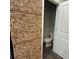 Unique powder room with wine cork accent wall and ceramic toilet at 201 Jonquil Spring Rd, Woodstock, GA 30188