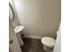 Half-bathroom featuring pedestal sink, toilet and neutral colors at 201 Jonquil Spring Rd, Woodstock, GA 30188