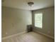 This bedroom offers a brightly lit atmosphere with a large window view at 201 Jonquil Spring Rd, Woodstock, GA 30188