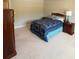 This bedroom features a comfortable bed with a blue quilt and a wooden headboard at 201 Jonquil Spring Rd, Woodstock, GA 30188