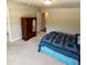 Spacious bedroom with neutral carpeting, large wardrobe, and bright natural light at 201 Jonquil Spring Rd, Woodstock, GA 30188