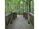 Walking bridge between wooden rails over natural landscape at 201 Jonquil Spring Rd, Woodstock, GA 30188