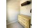 This closet features a yellow dresser with detailed carvings and a wire shelf for storage at 201 Jonquil Spring Rd, Woodstock, GA 30188