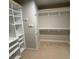 Spacious walk-in closet with neutral tones, shelving, and hooks at 201 Jonquil Spring Rd, Woodstock, GA 30188