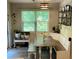 Cozy dining area featuring built-in bench seating, a window, and decorative wall shelves at 201 Jonquil Spring Rd, Woodstock, GA 30188