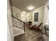Inviting entryway with staircase, wood floors, and stylish decor at 201 Jonquil Spring Rd, Woodstock, GA 30188