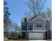 Charming two-story townhome featuring a one-car garage and inviting curb appeal at 201 Jonquil Spring Rd, Woodstock, GA 30188