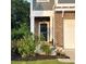 Well-maintained front entrance with garden featuring mature bushes and mulch beds at 201 Jonquil Spring Rd, Woodstock, GA 30188