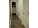 Hallway with hardwood floors leading to a laundry area with appliances at 201 Jonquil Spring Rd, Woodstock, GA 30188