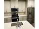 Spacious kitchen featuring stainless steel appliances, white cabinets, quartz countertop, and a subway tile backsplash at 201 Jonquil Spring Rd, Woodstock, GA 30188