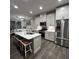 Modern kitchen with stainless steel appliances, island with seating, and sleek white cabinetry at 201 Jonquil Spring Rd, Woodstock, GA 30188