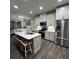 Bright kitchen features stainless steel appliances, white cabinets, and a large island at 201 Jonquil Spring Rd, Woodstock, GA 30188