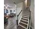 Open-concept living area with dark wood floors and staircase leading to upper level at 201 Jonquil Spring Rd, Woodstock, GA 30188