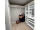 Spacious walk-in closet with custom shelving, hanging rods, and carpeted flooring for organized storage at 201 Jonquil Spring Rd, Woodstock, GA 30188