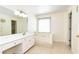 Bathroom featuring tiled floors, white cabinetry, tub and shower combination at 3200 Binghampton Ln, Lawrenceville, GA 30044