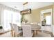 Elegant dining room featuring a modern chandelier, ample natural light, and a refined setting for memorable meals at 3200 Binghampton Ln, Lawrenceville, GA 30044