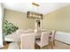 Bright dining room with modern light fixture, neutral colors, and stylish table setting that exudes elegance and comfort at 3200 Binghampton Ln, Lawrenceville, GA 30044