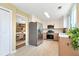Modern kitchen featuring stainless steel appliances, bright countertops, and seamless layout to the adjacent dining area at 3200 Binghampton Ln, Lawrenceville, GA 30044