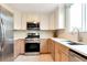 Contemporary kitchen boasts stainless steel appliances, ample cabinetry, bright countertops, and modern fixtures for a functional design at 3200 Binghampton Ln, Lawrenceville, GA 30044