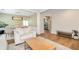 Open-concept living room featuring wood floors, stylish furnishings, and a seamless transition to the dining area at 3200 Binghampton Ln, Lawrenceville, GA 30044