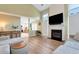 Open living room with a fireplace and kitchen view, offering a bright and modern living space at 3200 Binghampton Ln, Lawrenceville, GA 30044