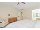 Well-lit main bedroom with carpet, ceiling fan, seating area and light neutral tones at 3200 Binghampton Ln, Lawrenceville, GA 30044