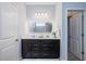 Bright bathroom with double sinks, a large mirror, and neutral paint; toilet is hidden from view at 5440 Wheeler Ridge Rd, Auburn, GA 30011