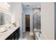 Bright bathroom with double sinks, a soaking tub, a tiled shower, and a walk-in closet at 5440 Wheeler Ridge Rd, Auburn, GA 30011