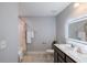 Modern bathroom featuring double vanity, illuminated mirror, gray tile flooring, and a shower, providing a luxurious feel at 5440 Wheeler Ridge Rd, Auburn, GA 30011
