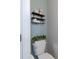 Stylish bathroom decor featuring floating shelves, towels, and a decorative plant above the toilet at 5440 Wheeler Ridge Rd, Auburn, GA 30011
