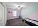 Stylized room featuring a unique car-shaped bed, gray carpet and pastel accent walls, creating a playful space at 5440 Wheeler Ridge Rd, Auburn, GA 30011