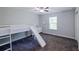 Bright bedroom featuring gray carpet, a built-in loft bed with slide and natural light, creating a fun space at 5440 Wheeler Ridge Rd, Auburn, GA 30011